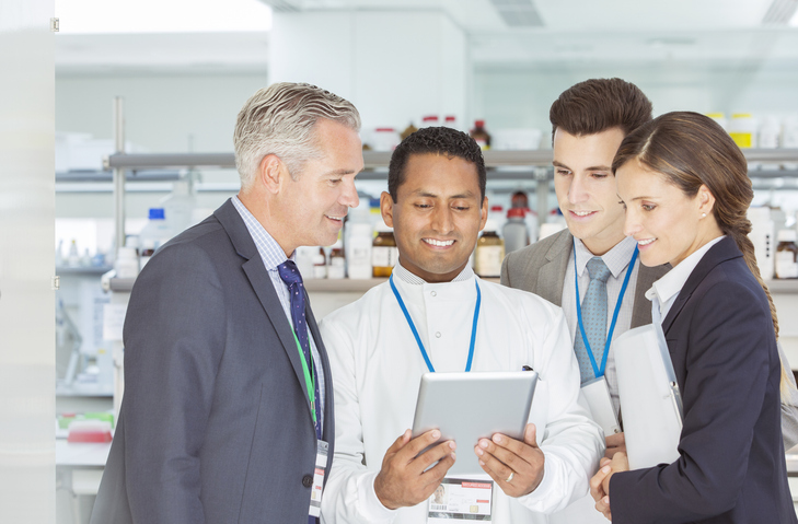 Scientist and business people using digital tablet in laboratory