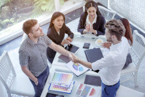 Team Business Partners shaking hands together to Greeting Start up small business in meeting room. Shakehand teamwork partners at modern office handshake together. Business mergers and acquisitions