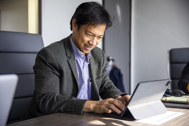 A Mature Filipino Man Working in Team Meeting in Conference Room